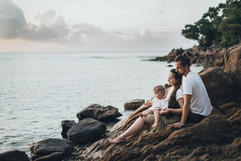 family sitting on rocks