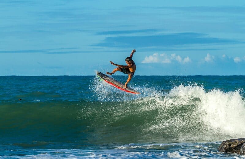 man surfing sea beach